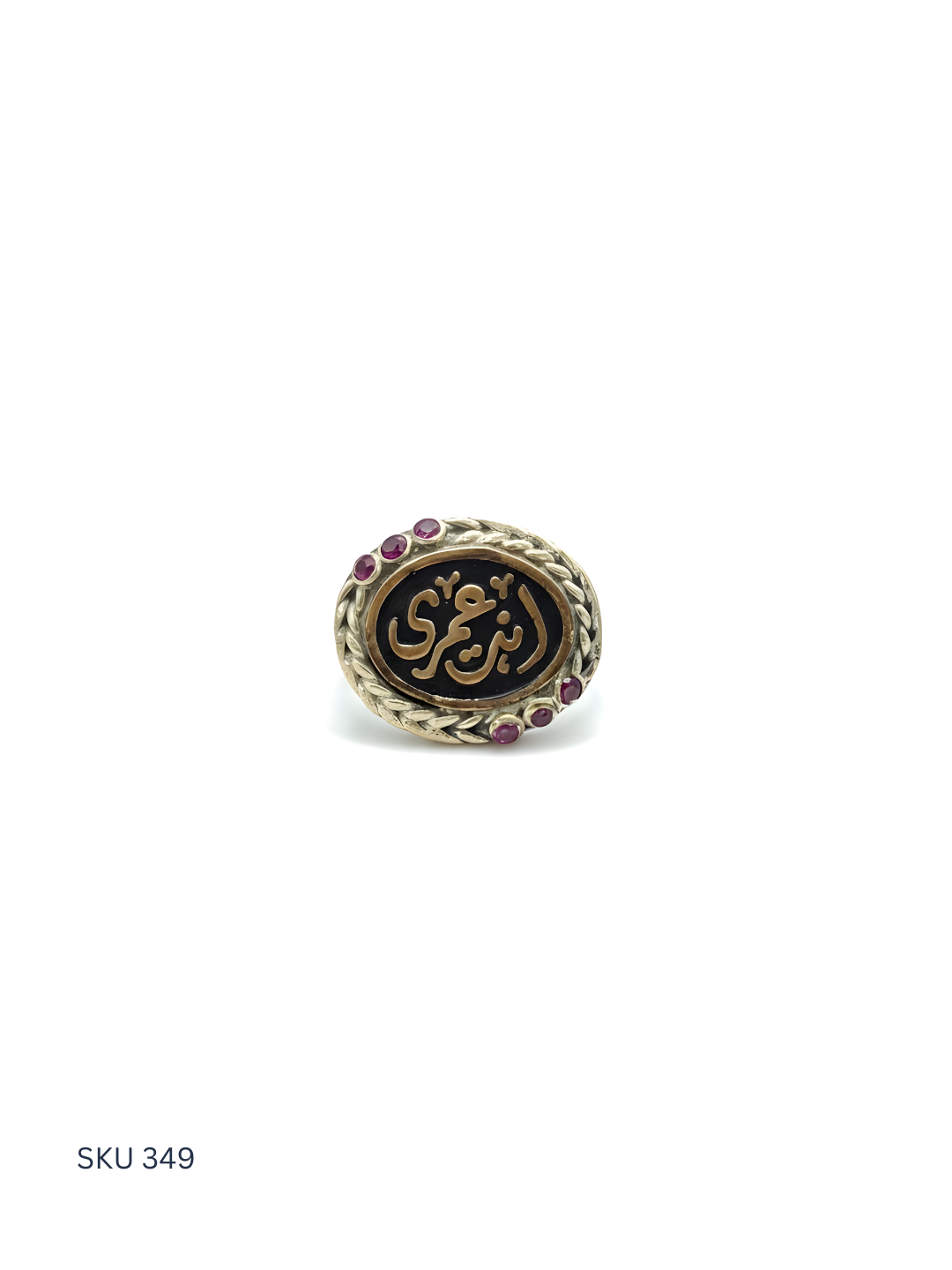 Decorative ring with Arabic calligraphy and gemstones on a white background