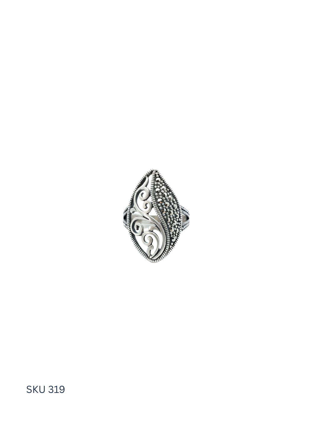 Silver ring with intricate design on a white background