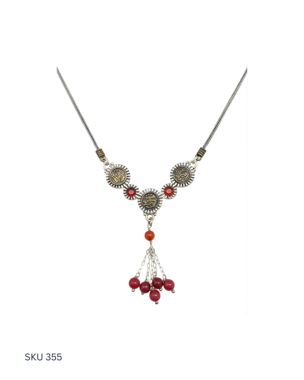 Necklace with red beads and silver accents on a white background
