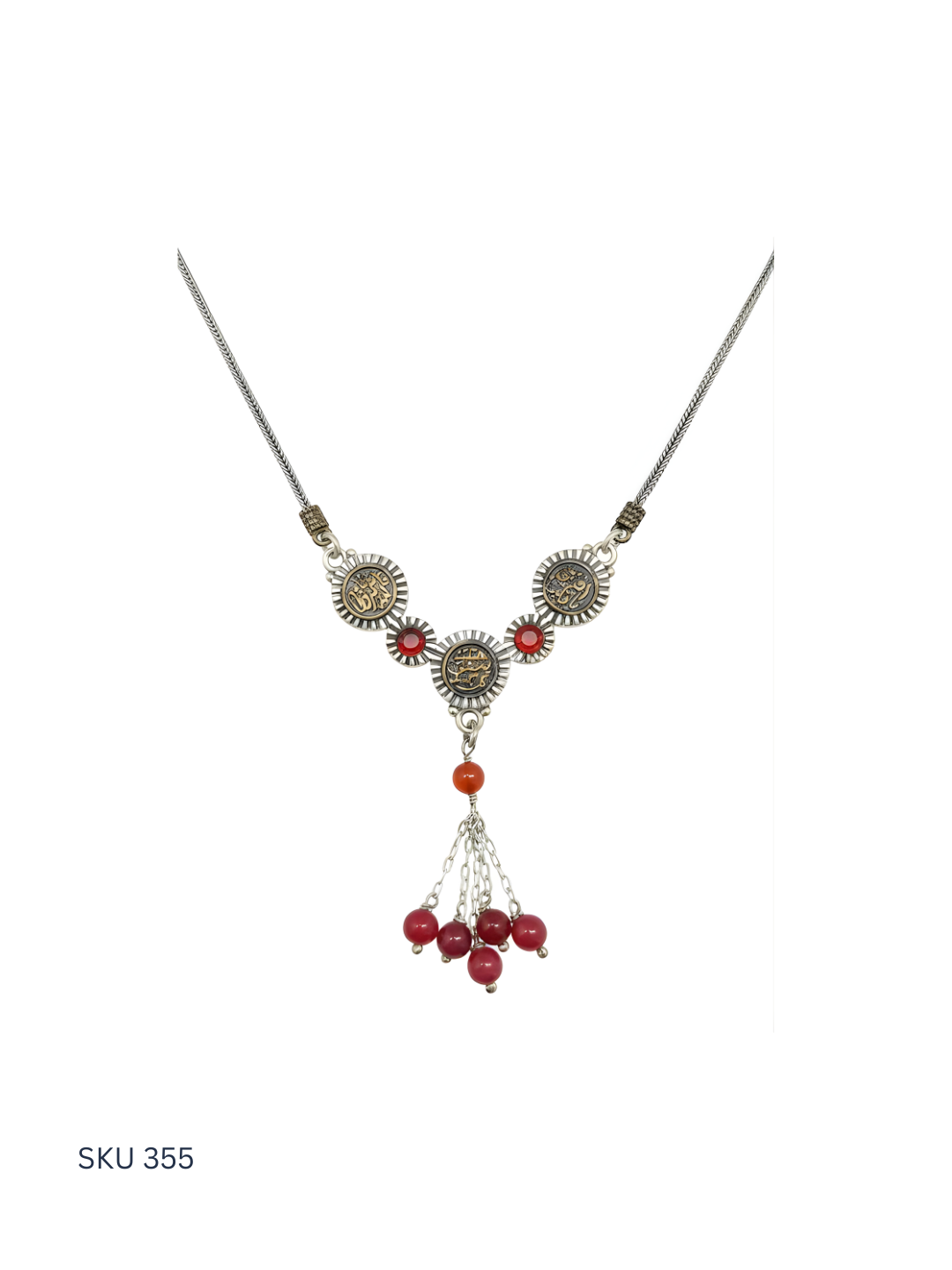 Necklace with red beads and silver accents on a white background